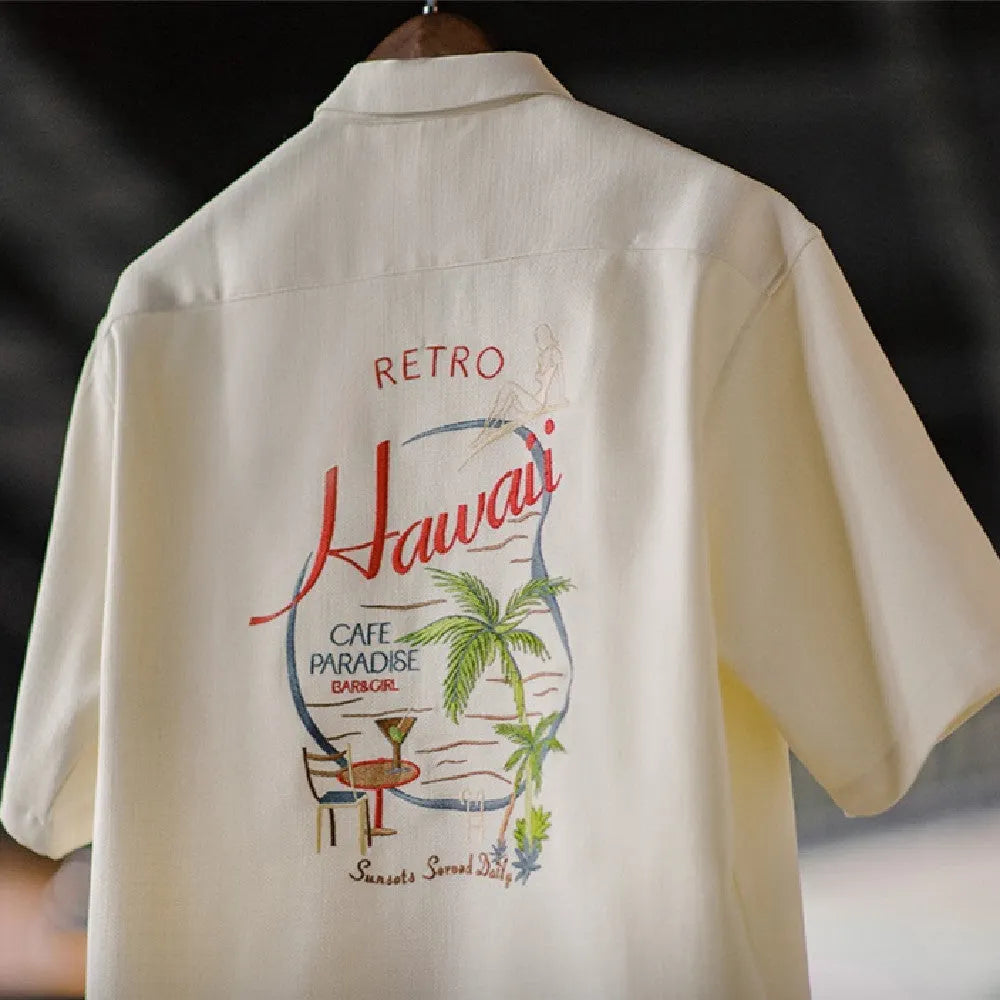 Light apricot coloured men's shirt with a bamboo and floral pattern and a Cuban collar.