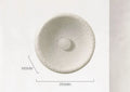 Japanese minimalist wall lamp with a round resin shade, shown in a modern room setting.