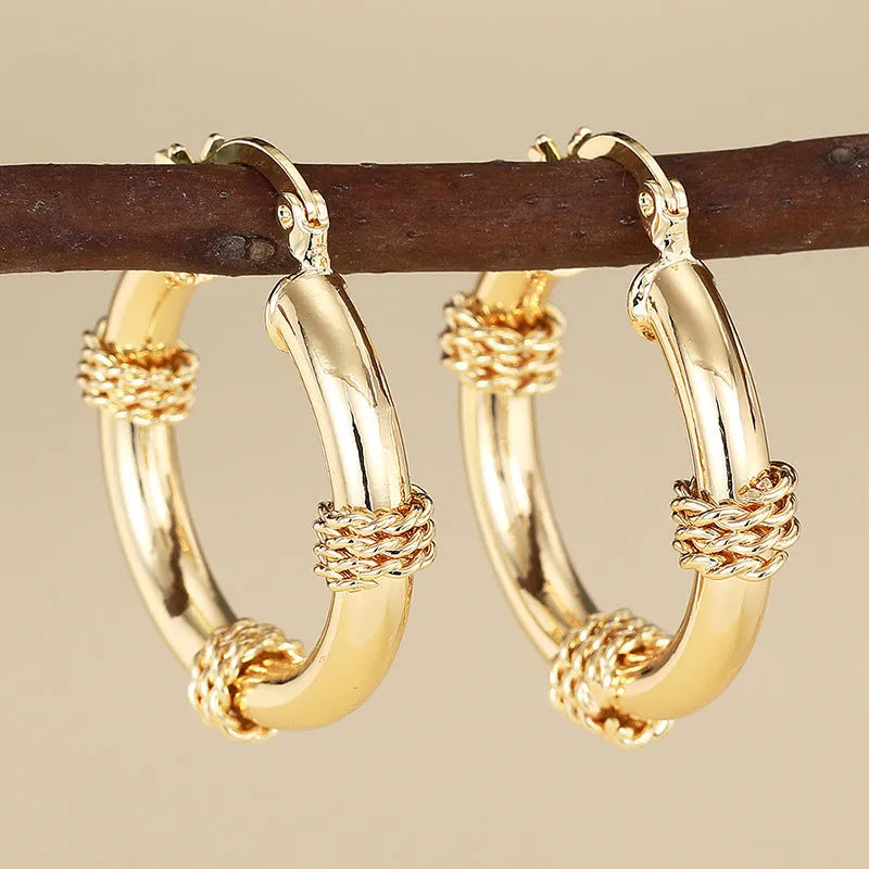 Geometric copper clip-on earrings for women with ring and line design in a golden finish.