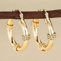Geometric copper clip-on earrings for women with ring and line design in a golden finish.