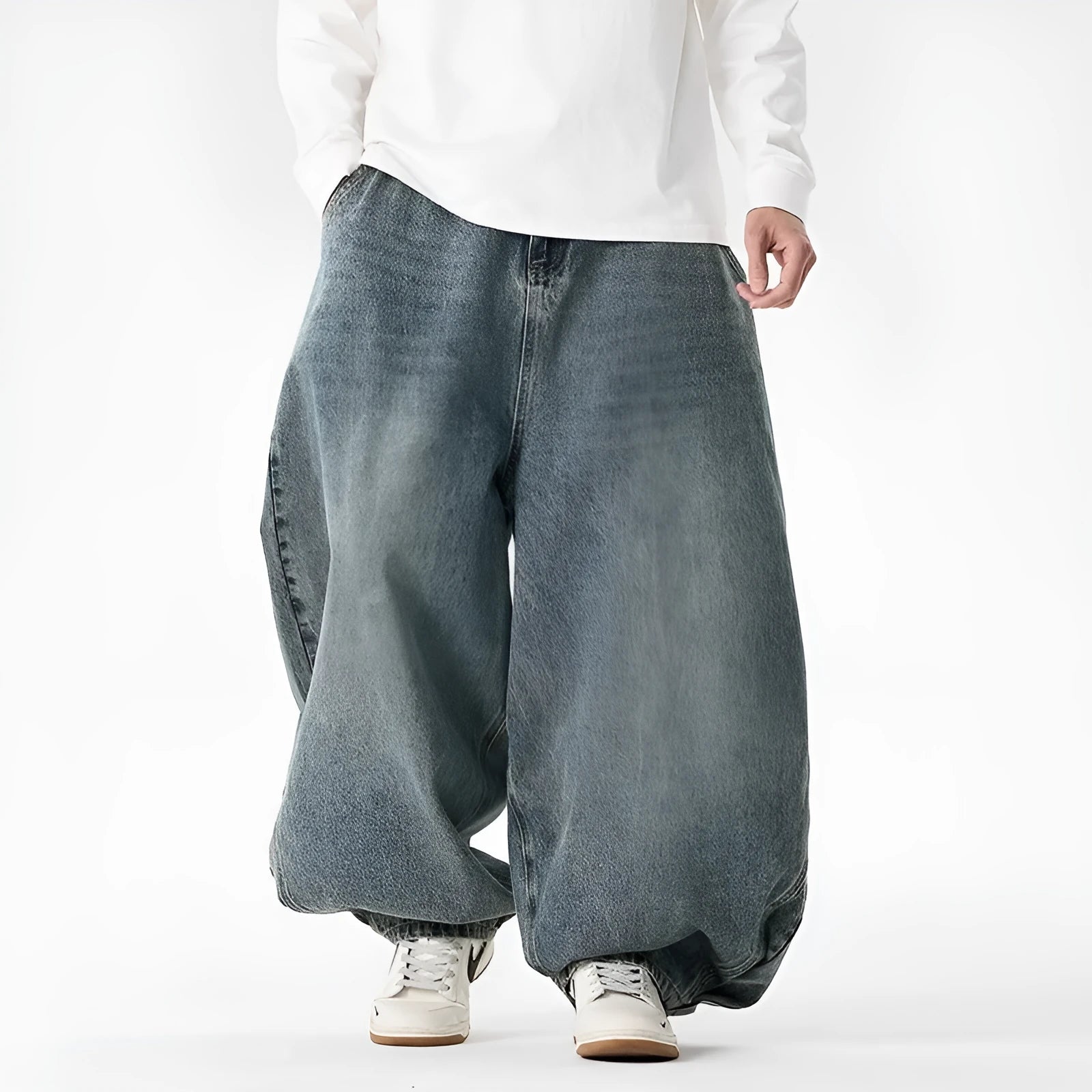 Man wearing light blue plus-size wide-leg casual denim jeans with a baggy fit and straight leg opening.