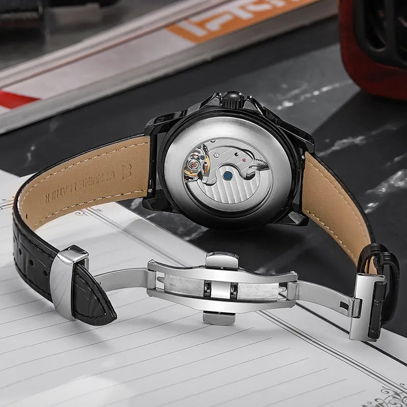Men's automatic watch with black dial and steel bracelet showing luminous hands.