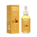 30ml glass bottle of turmeric honey essential oil with a dropper on a wooden surface.