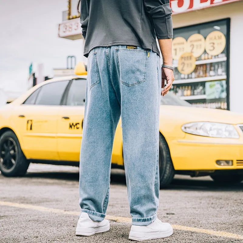Men's loose fit straight leg jeans in cotton denim shown in dark blue, mid waist with zipper fly
