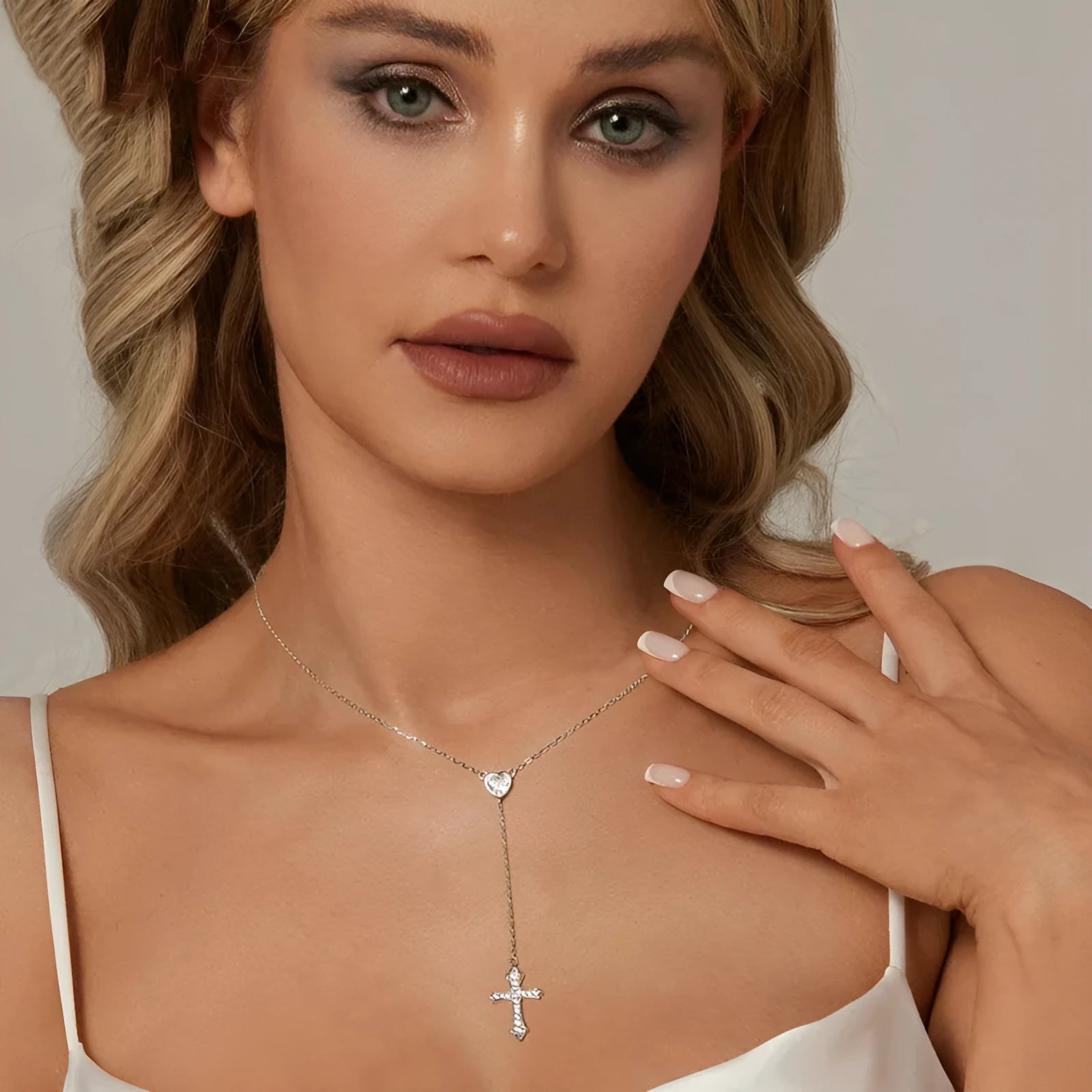 Simple silver love cross pendant necklace with O-ring chain on a female model, colour BSN384.