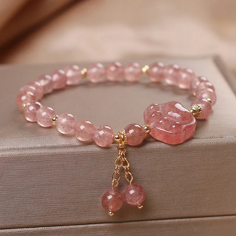 Women's double layer crystal bracelet with lucky cat charm and red cat's eye flowers.