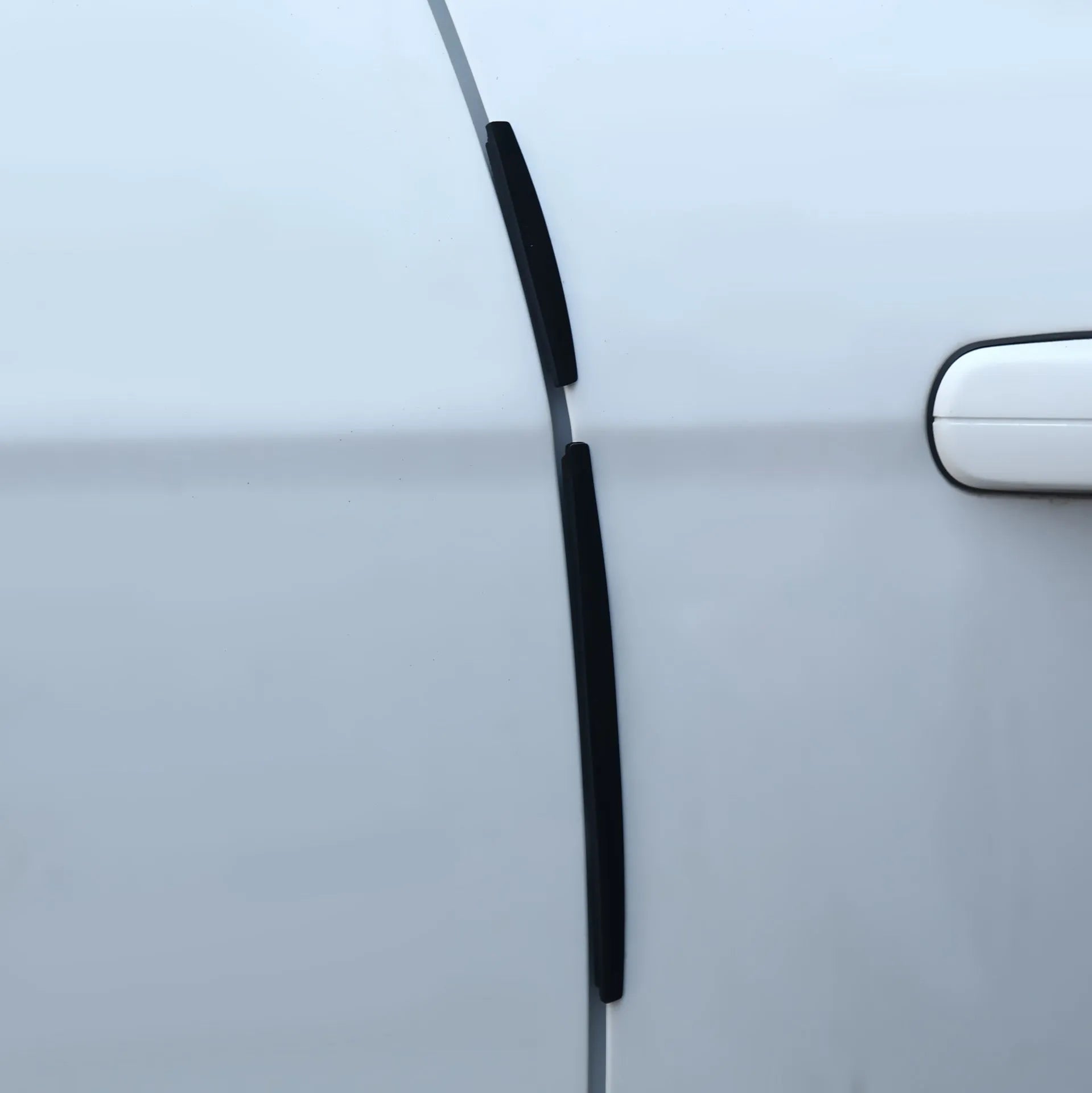 White plastic adhesive car door edge protection bumper strip roll.