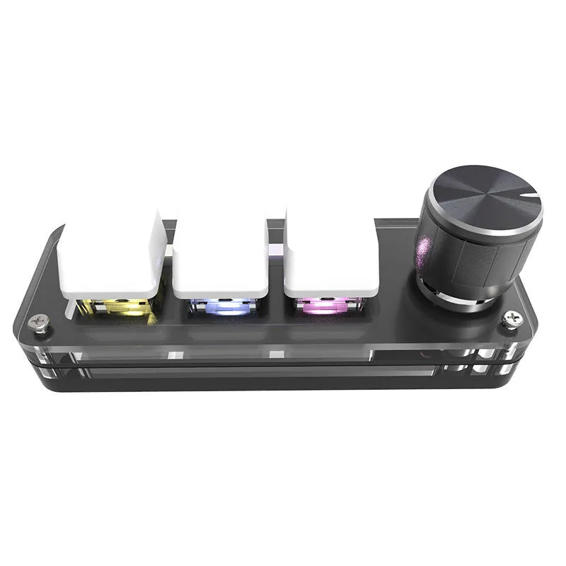 Compact black USB keypad with RGB colourful backlighting on a desk.