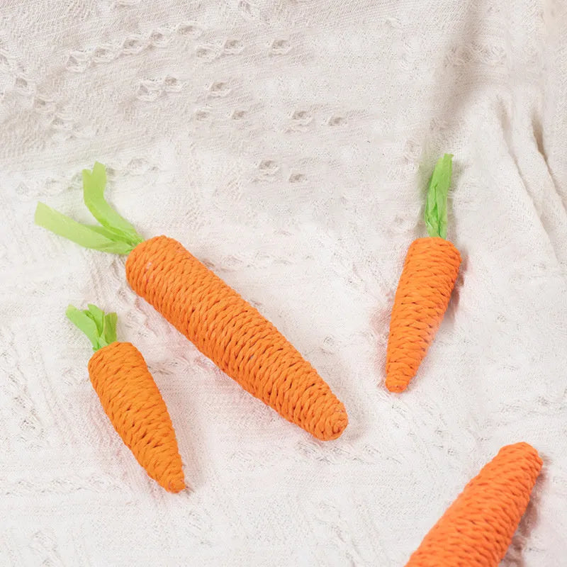 Assortment of interactive cat toys including carrot bites, paper toys, ringing stones, sticks, and grinding toys