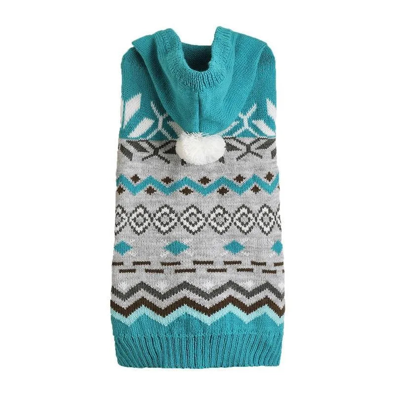 Green knitted pet sweater with diamond pattern on a small dog, showing size and texture.