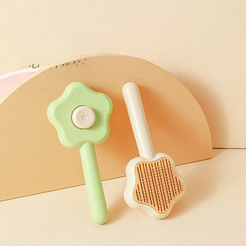 Green self-cleaning stainless steel cat comb with needle teeth on a 20cm handle.