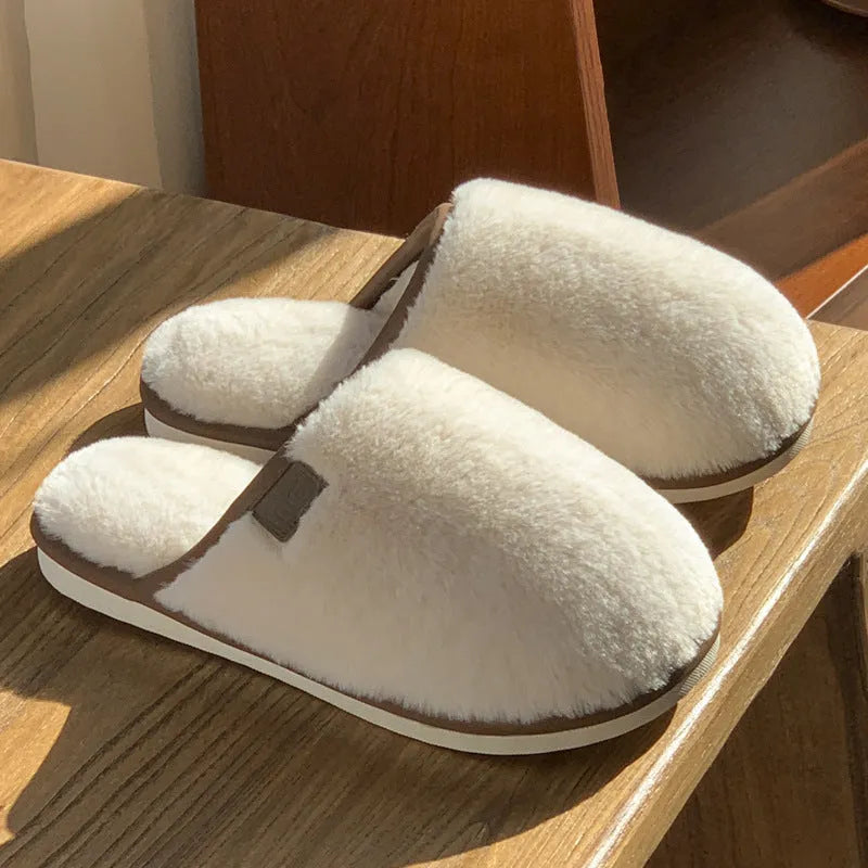 Winter plush slippers in blue colour with non-slip PVC soles, showing car stitching detail
