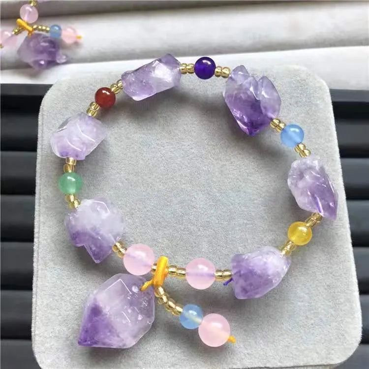 Natural purple amethyst bead bracelet for women with a fu character charm on a white background.