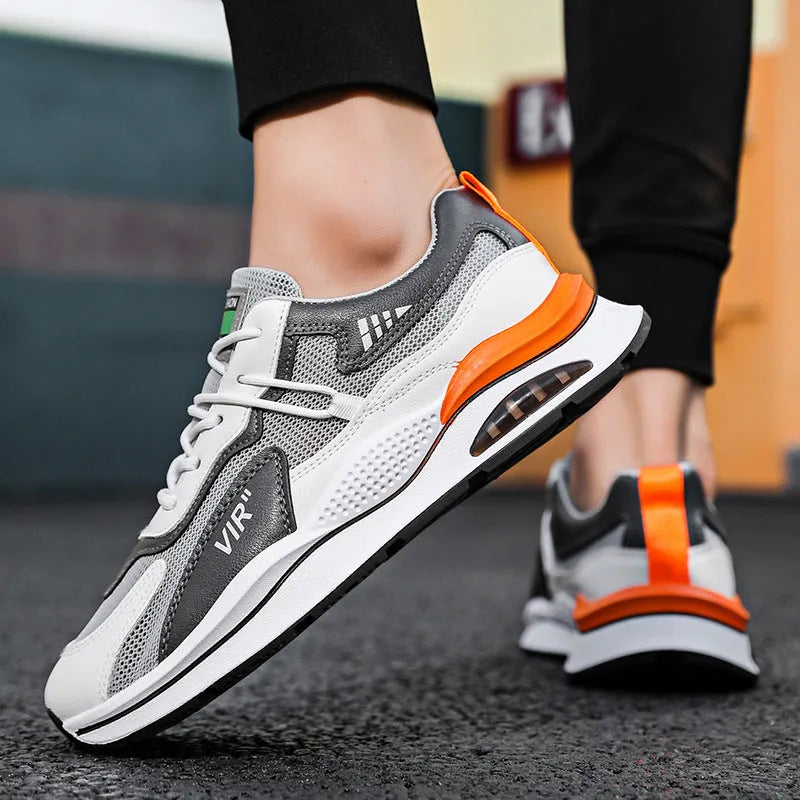 Men's gray mesh running shoes with round toe and visible stitching, shown from side view