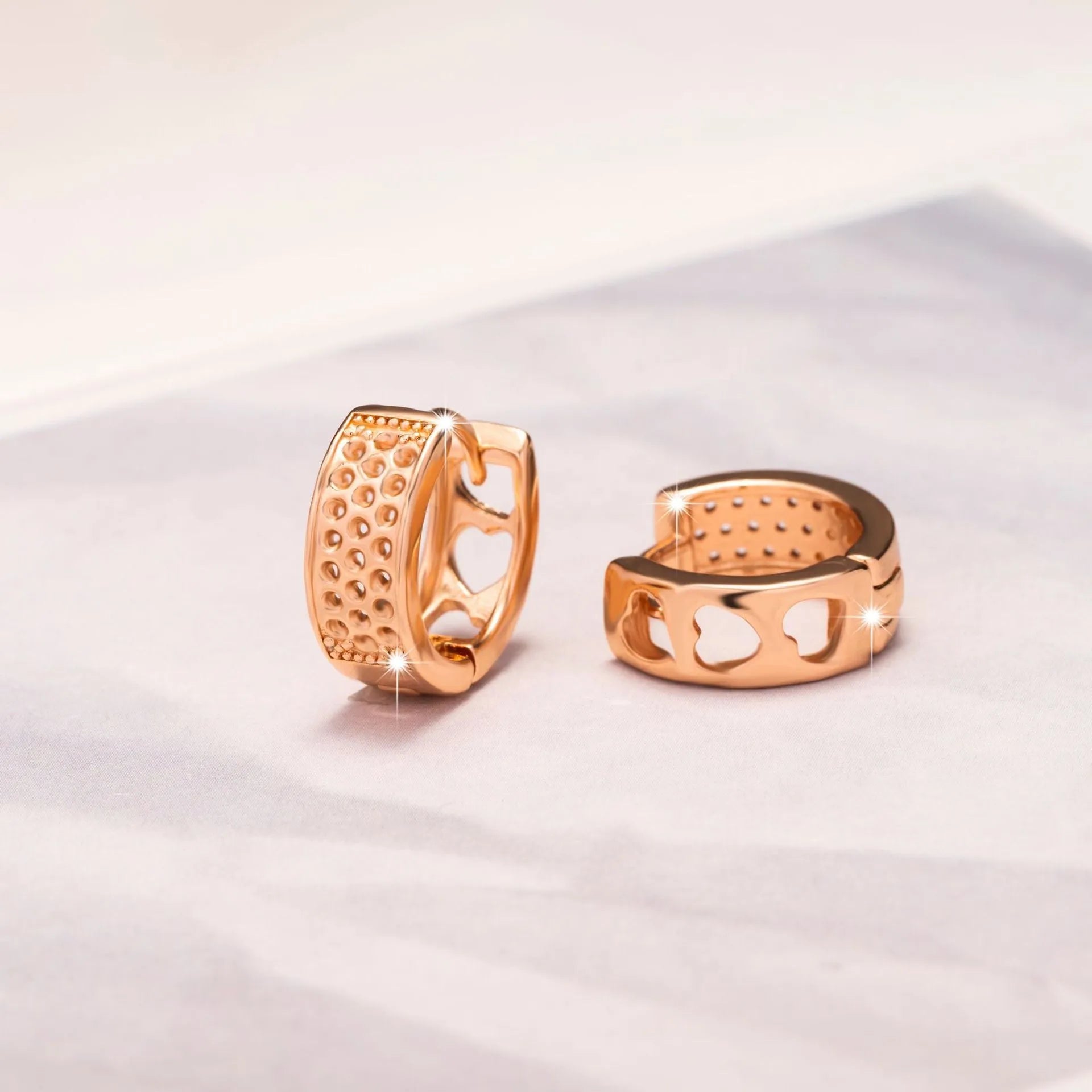 Rose gold hollowed heart earrings with circular shape and electroplated finish
