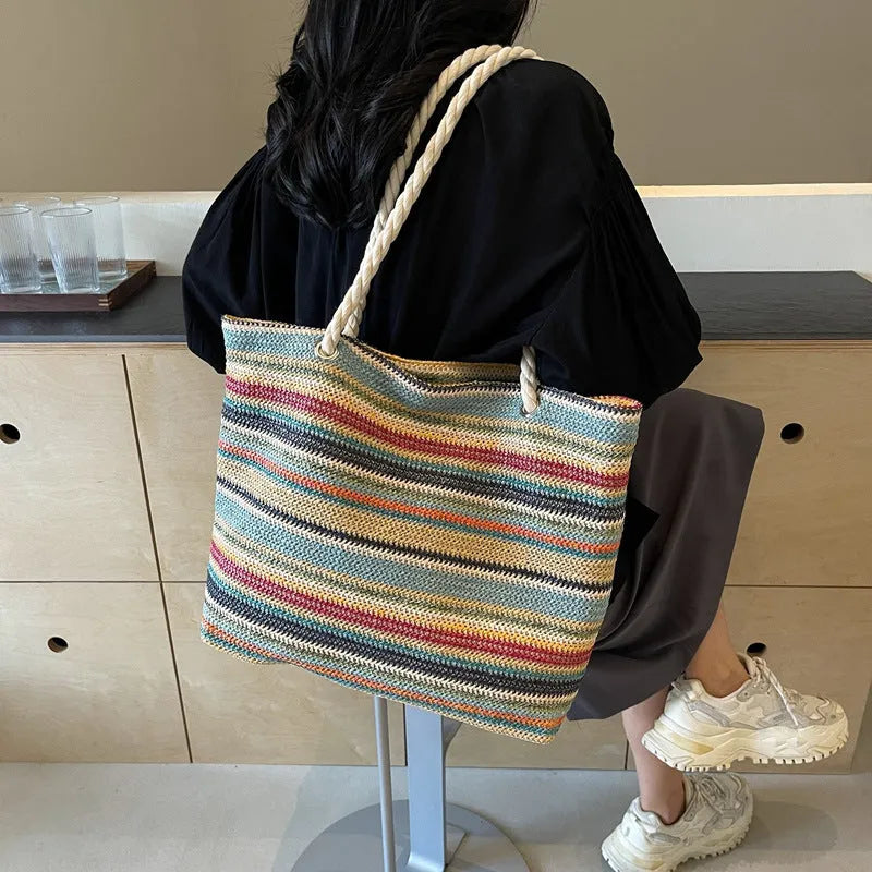 Blue woven nylon shoulder bag with large capacity and textured straw-like design