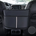 Black leather car seat storage bag with carbon fibre pattern, shown fitting between car seats.
