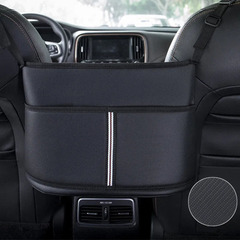 Black leather car seat storage bag with carbon fibre pattern, shown fitting between car seats.