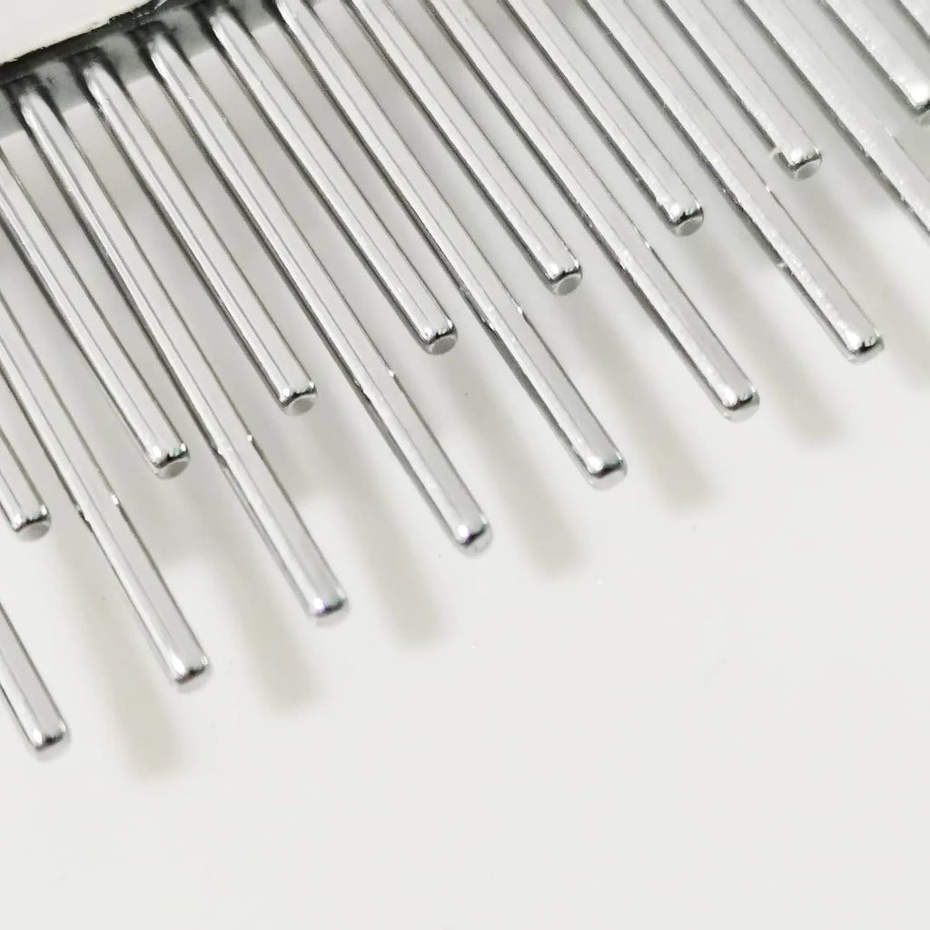 Red plastic handle pet comb with alternating rows of short and long stainless steel teeth for dematting tangles.