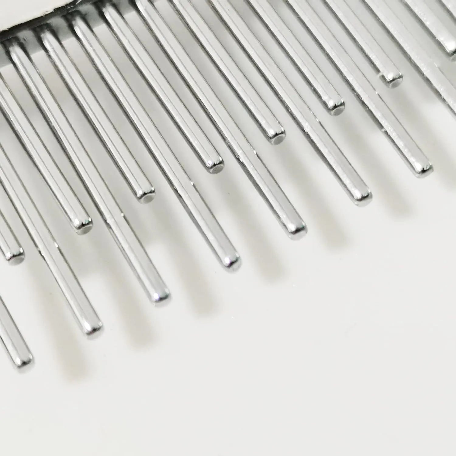 Red plastic handle pet comb with alternating rows of short and long stainless steel teeth for dematting tangles.