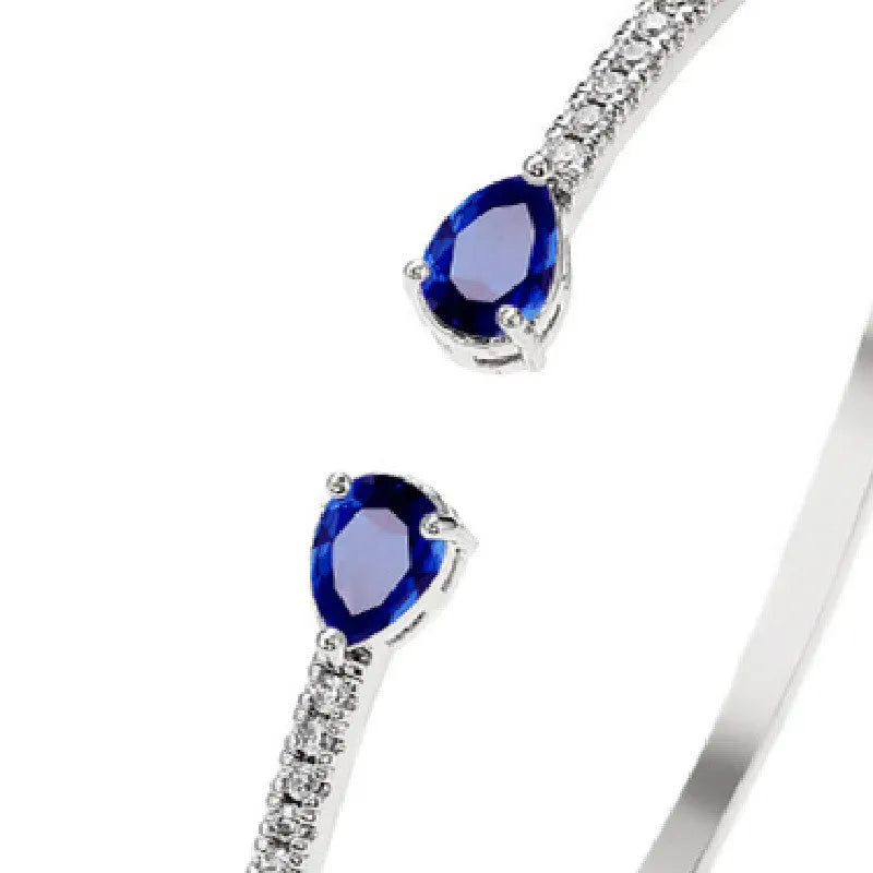 Copper fashion bracelet with multi-zircon inlay decoration, shown in white and blue colour options.