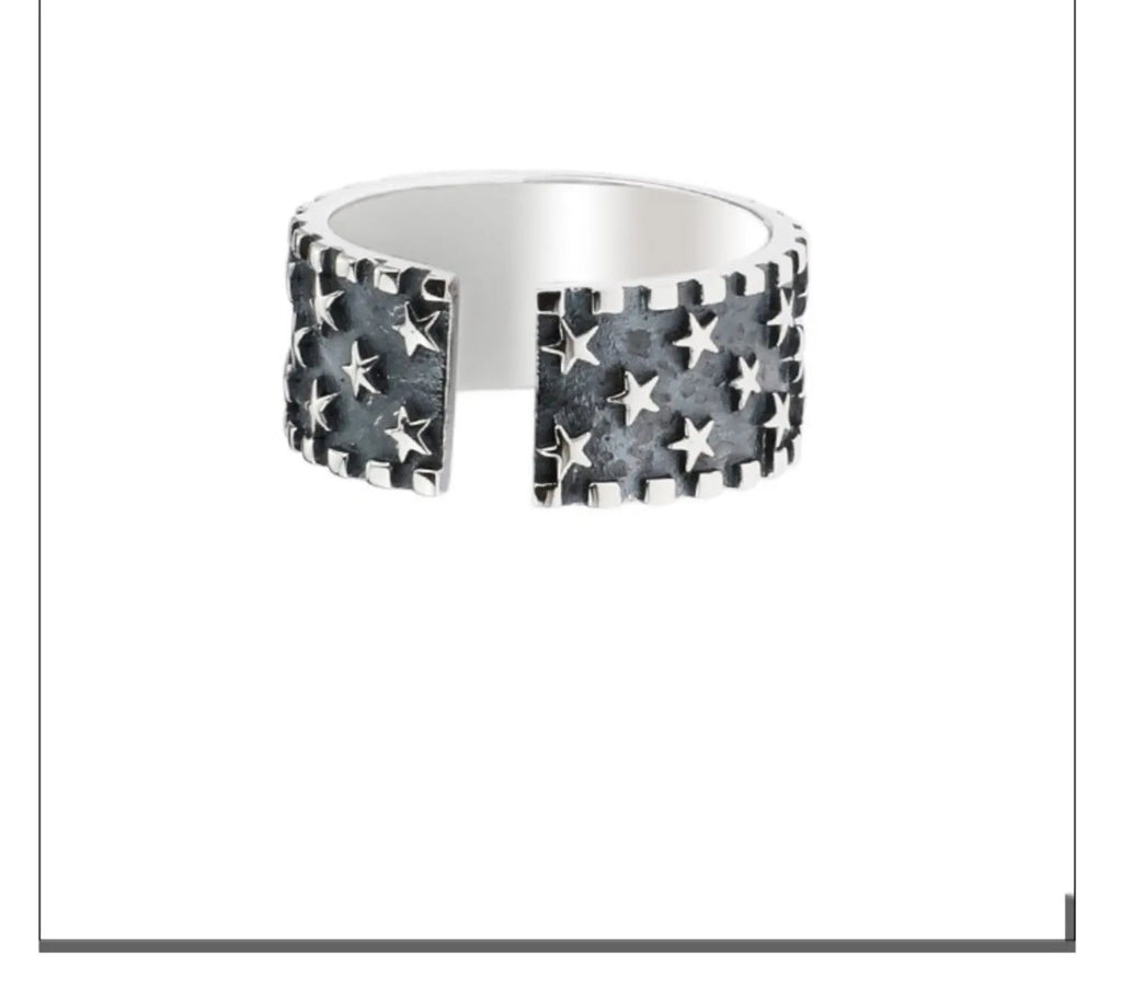 Silver adjustable ring with geometric five pointed star pattern on finger