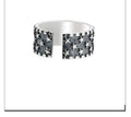 Silver adjustable ring with geometric five pointed star pattern on finger