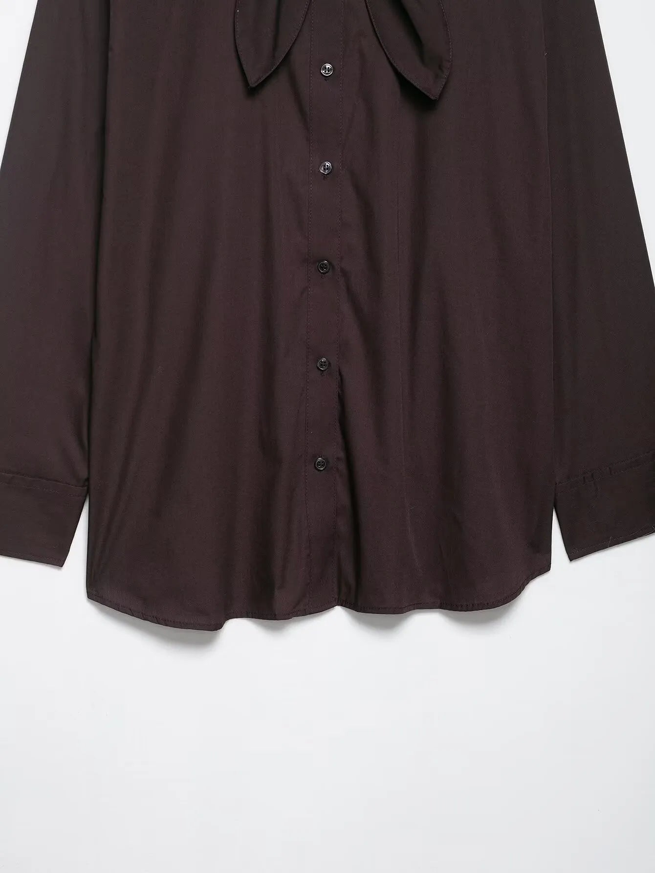 Brown women's poplin shirt with long sleeves, a loose fit, and a bow tie front closure.