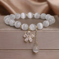 White cat's eye crystal bracelet with flower tassels and morganite safety buckle pendant