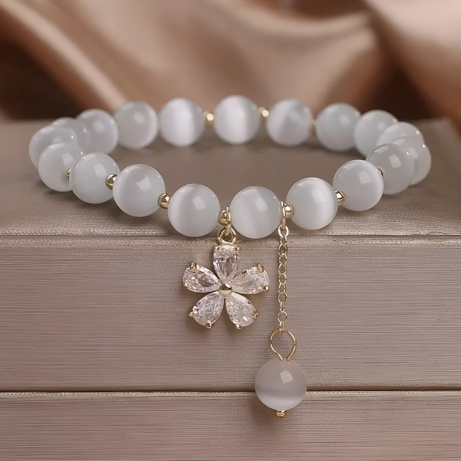 White cat's eye crystal bracelet with flower tassels and morganite safety buckle pendant