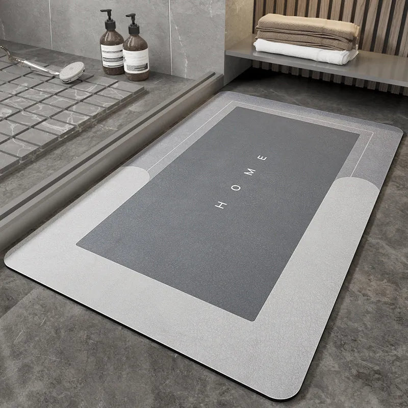 Blended fibre machine woven bathroom floor mat in blue, shown in an oval shape on a tiled floor.