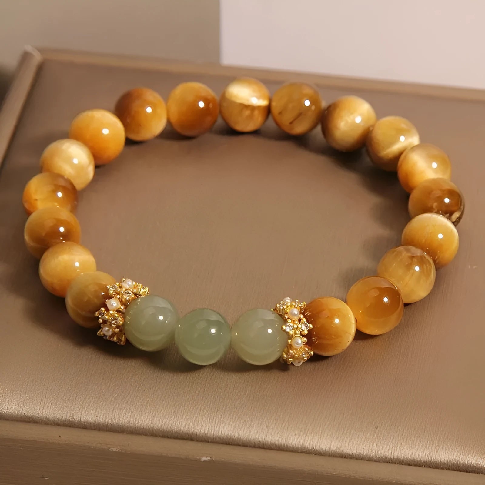 Natural yellow tiger's eye Hetian jade bracelet in u-shaped design with auspicious patterns.