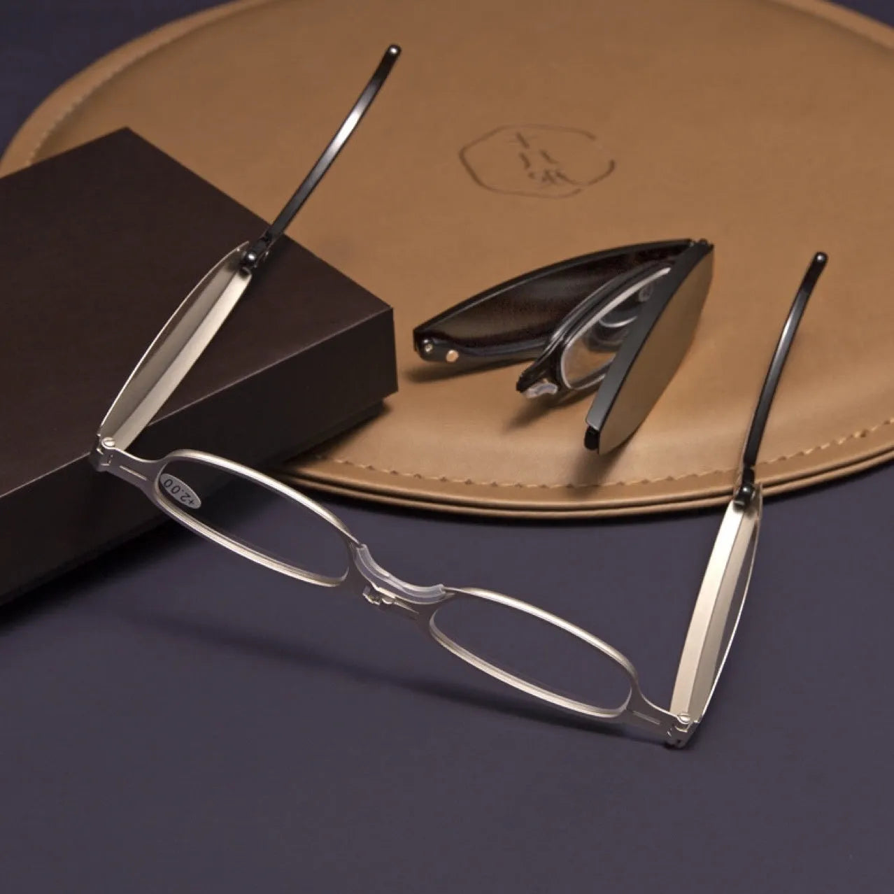 Folding presbyopic glasses with retro ring design in black frame collapsed for pocket storage