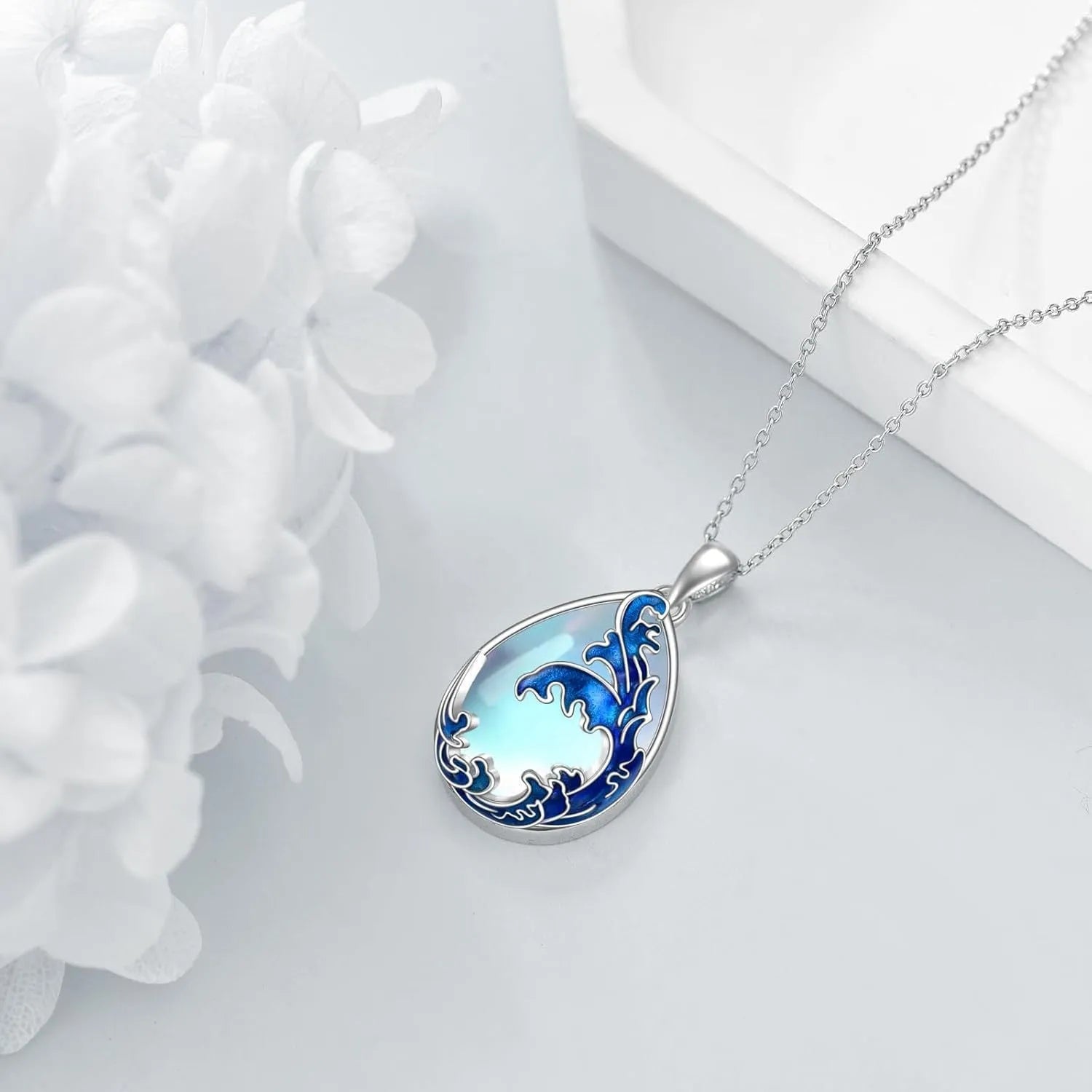 Blue heart-shaped alloy pendant necklace on a chain.