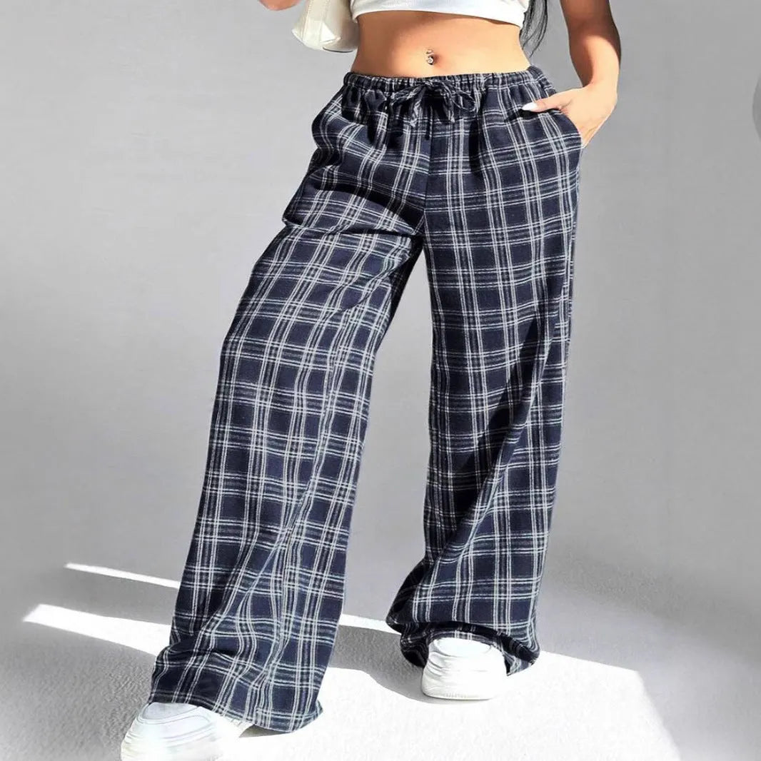 Women's red plaid casual trousers with drawstring waist and patch pockets laid flat