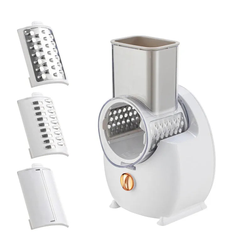 White electric vegetable slicer with rotary grater, feeding port, and three blade pairs on kitchen counter