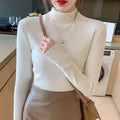 Women's slim fit long sleeve viscose knit top in a neutral colour on a hanger.