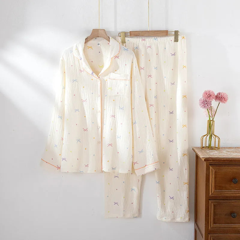 Women's long sleeve cotton pajama set in pink, featuring a top and trousers for sleepwear.