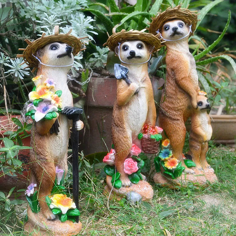 Three straw hat mongoose garden ornaments including mother and child, rake carrier, and shovel carrier designs