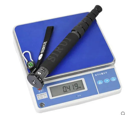 Black carbon fibre SLR camera monopod extended to full height with six sections visible