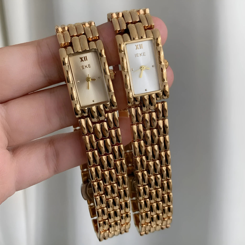 Women's silver and gold bracelet-style vintage watch with 15mm dial and butterfly clasp.
