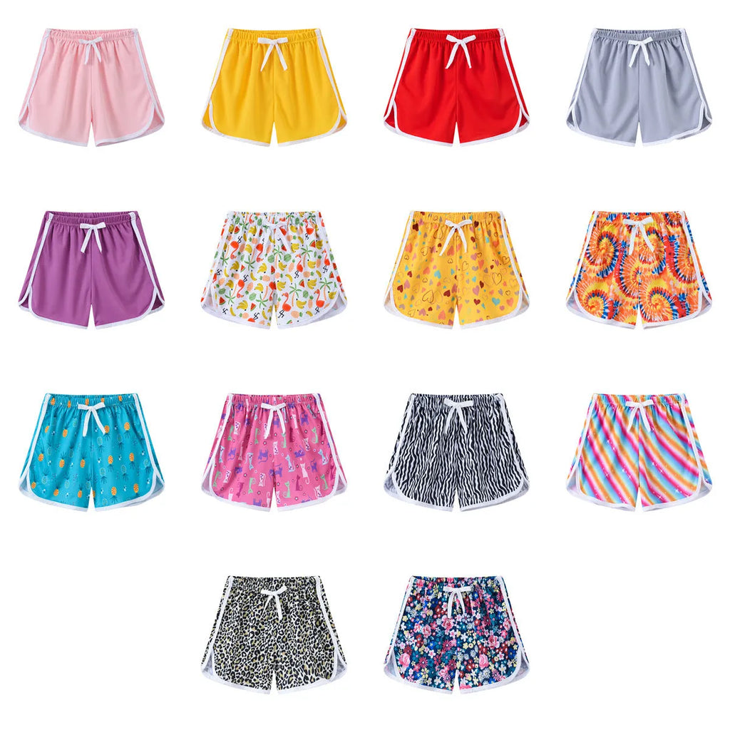 Children's polyester holiday shorts in various colours and patterns for beach wear