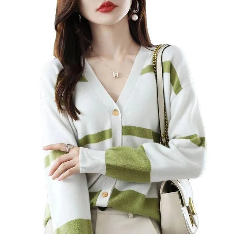 Woman wearing a slim fit V-neck knitted cardigan with a black and white 3D striped pattern