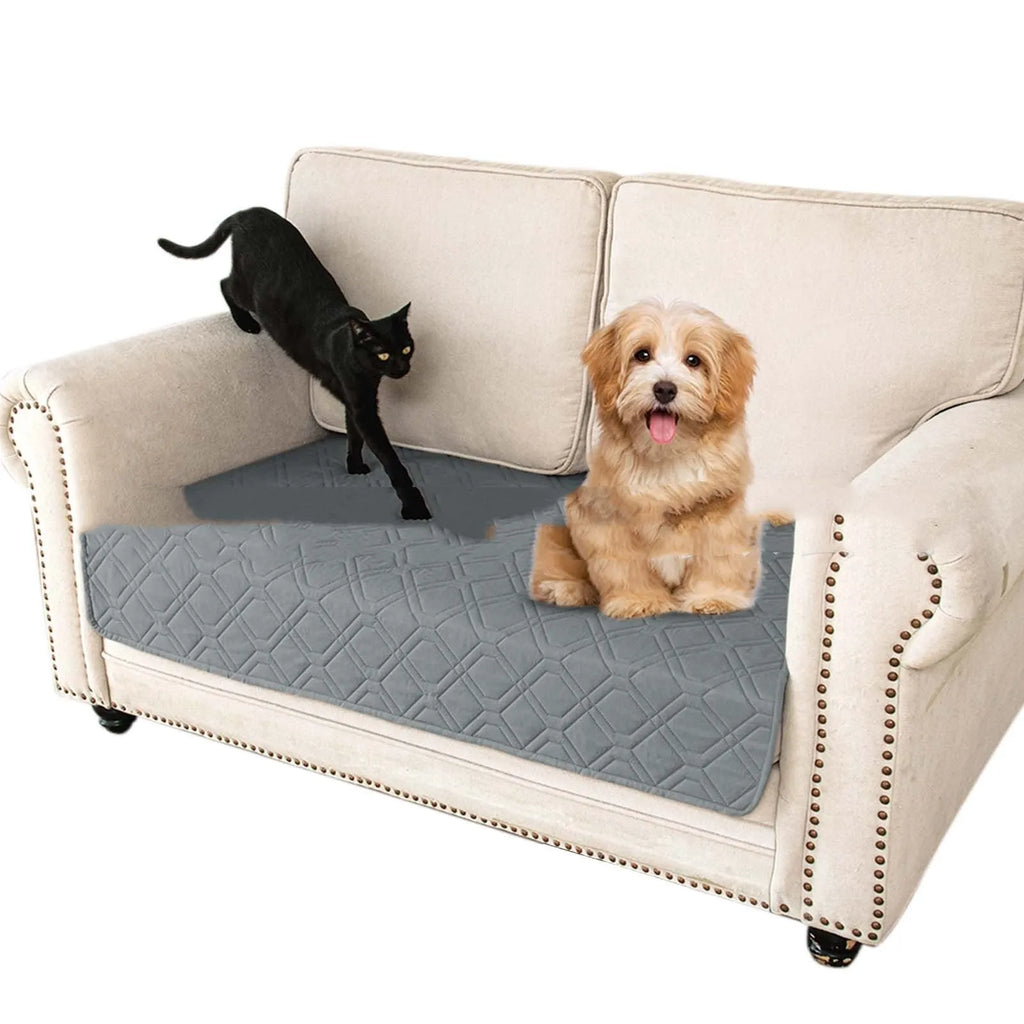 Reversible waterproof dog sofa cushion in dark grey and light grey contrast colours on a sofa.