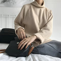 Women's solid colour long sleeve top with half-high collar in loose fit, shown in apricot