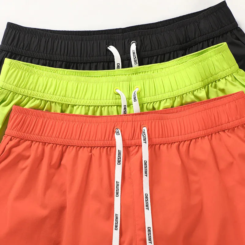 Men's loose beach shorts in orange red, fluorescent green and black colours with micro elasticity fabric