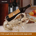 Lobster-shaped wine rack ornament in metallic rose gold or silver finish displaying wine bottle