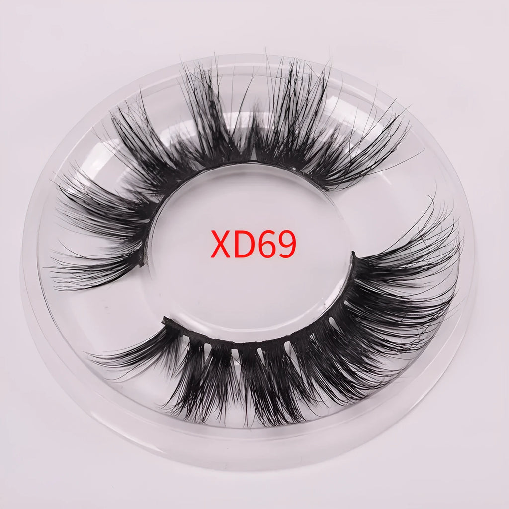 5D mink false eyelashes set with hair storage cap and double-headed brush on a clean surface.
