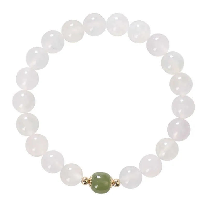 A handmade white agate style crystal bracelet with cinnabar inlay, shown in 6mm and 8mm bead sizes.