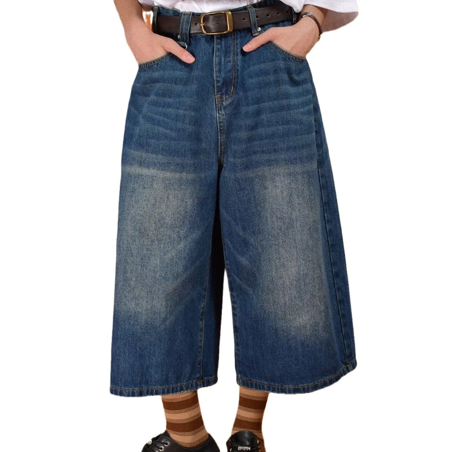 Man wearing blue loose-fit denim shorts on a summer day